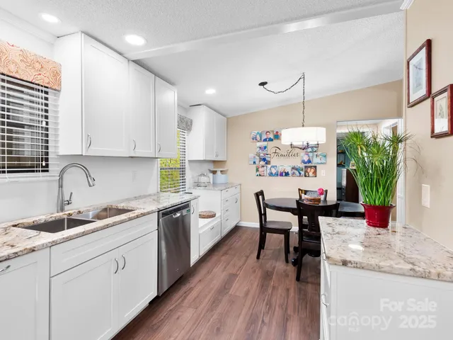 a kitchen with a table chairs stove and cabinets