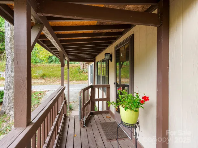 a view of a porch with wooden floor