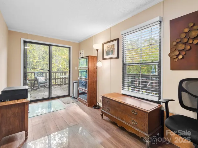 a room with furniture pool table and windows