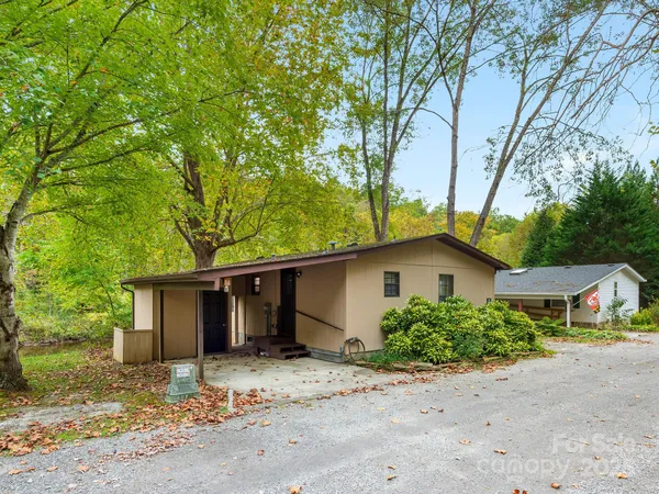 a view of a yard with a house and a tree