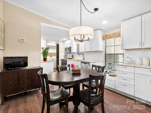 a kitchen with a dining table and chairs
