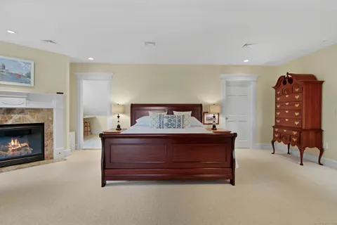 a bed room with a bed and a chair
