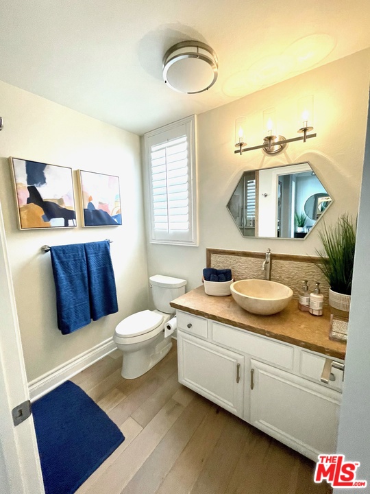 26810 Kendall Lane Stevenson Ranch, CA 91381 - Photo 11 of 44 a bathroom with a granite countertop sink mirror vanity and a toilet