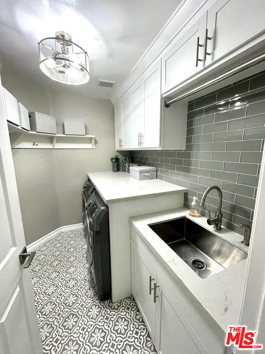 26810 Kendall Lane Stevenson Ranch, CA 91381 - Photo 19 of 44 a kitchen with a sink and cabinets
