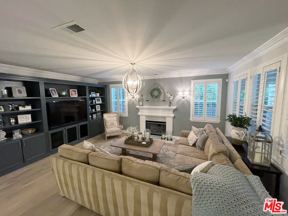 26810 Kendall Lane Stevenson Ranch, CA 91381 - Photo 22 of 44 a living room with furniture a fireplace and a flat screen tv