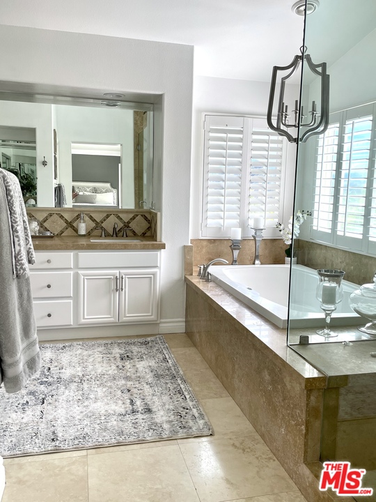 26810 Kendall Lane Stevenson Ranch, CA 91381 - Photo 28 of 44 a spacious bathroom with a tub sink and mirror