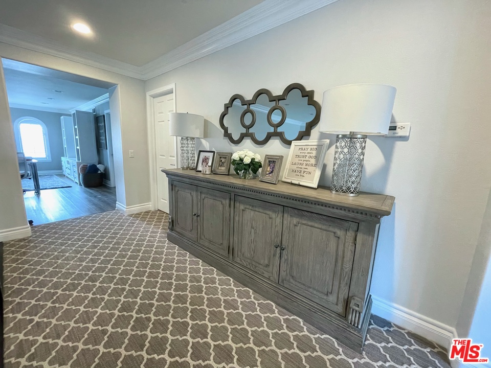26810 Kendall Lane Stevenson Ranch, CA 91381 - Photo 31 of 44 a living room with a couch and a chandelier