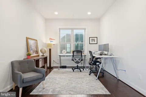 a living room with furniture potted plant and a window