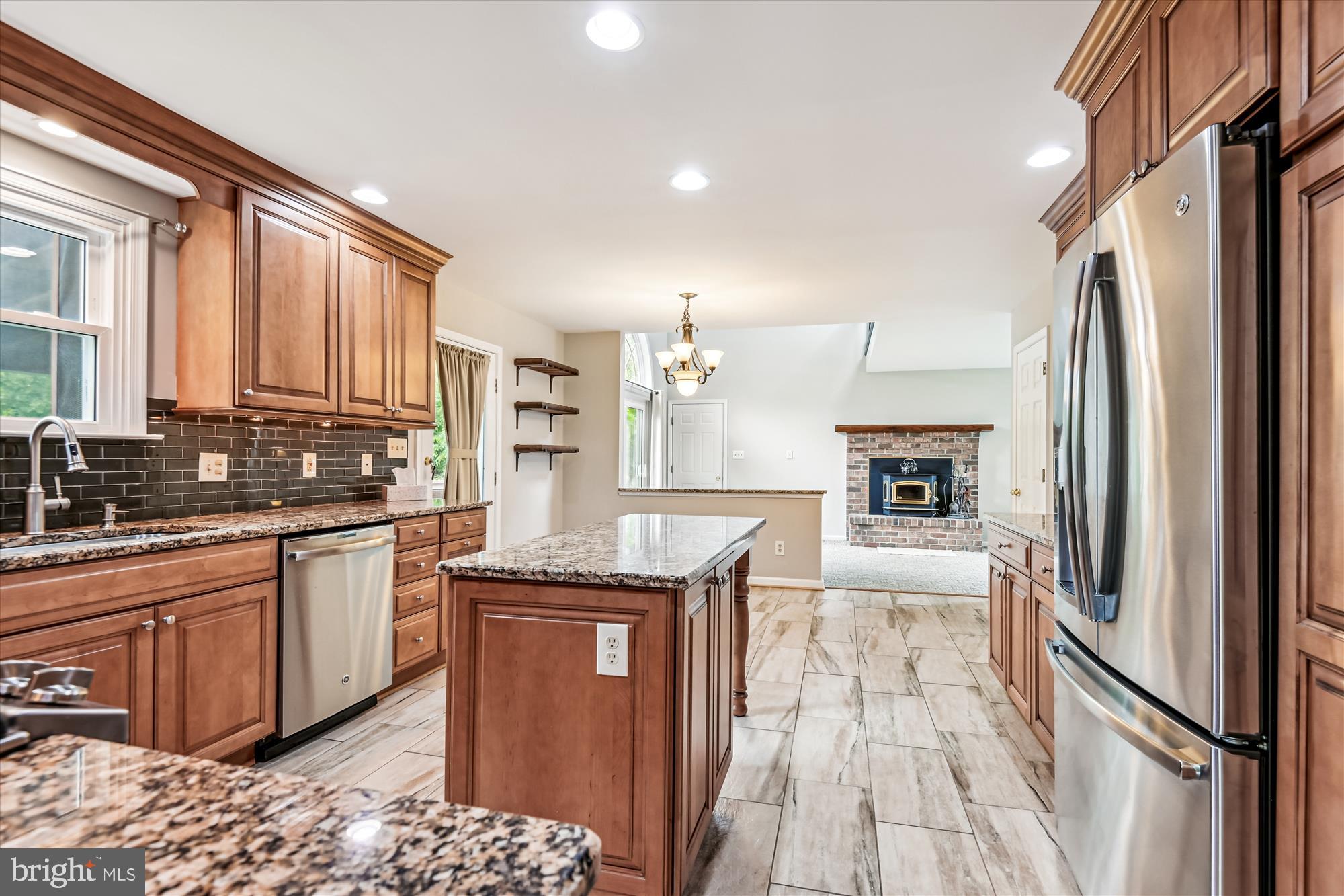 1302 Terry Way Fallston, MD 21047 - Photo 16 of 51 a kitchen with stainless steel appliances granite countertop a refrigerator a sink dishwasher a stove and white countertops with wooden floor