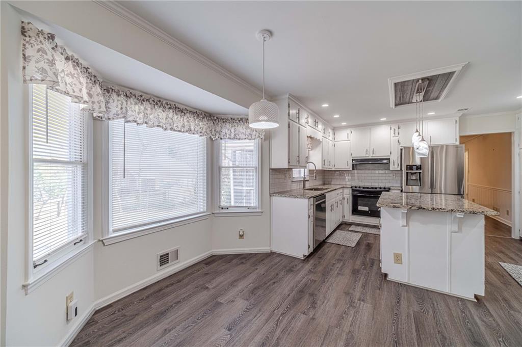 492 New Hope Road Lawrenceville, GA 30046 - Photo 13 of 48 a kitchen with kitchen island white cabinets and stainless steel appliances