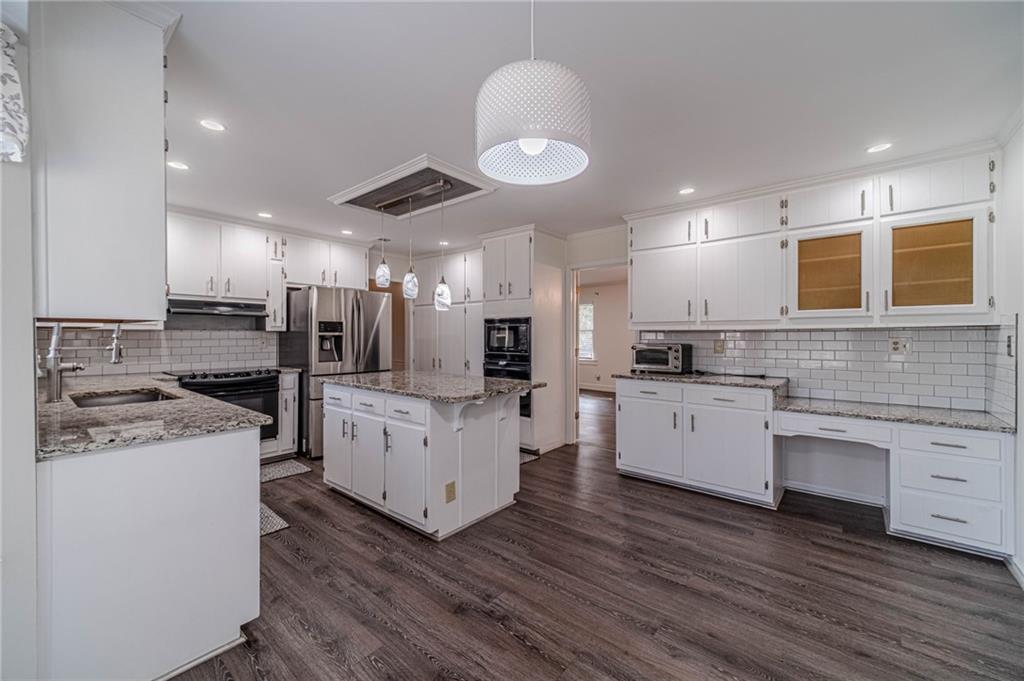 492 New Hope Road Lawrenceville, GA 30046 - Photo 14 of 48 a kitchen with stove a sink and a refrigerator