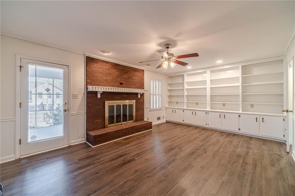 492 New Hope Road Lawrenceville, GA 30046 - Photo 17 of 48 an empty room with wooden floor fireplace and windows