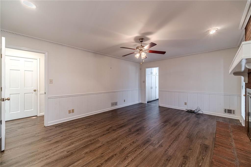 492 New Hope Road Lawrenceville, GA 30046 - Photo 18 of 48 an empty room with wooden floor and chandelier fan