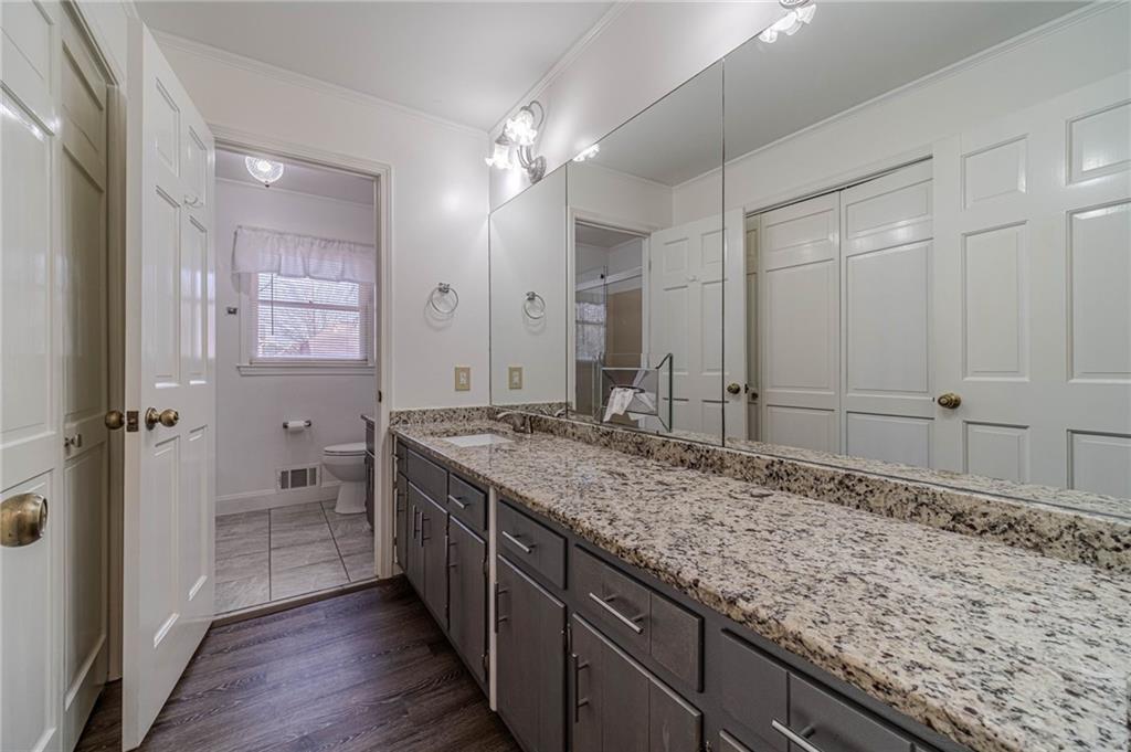 492 New Hope Road Lawrenceville, GA 30046 - Photo 22 of 48 a bathroom with a granite countertop sink and a mirror