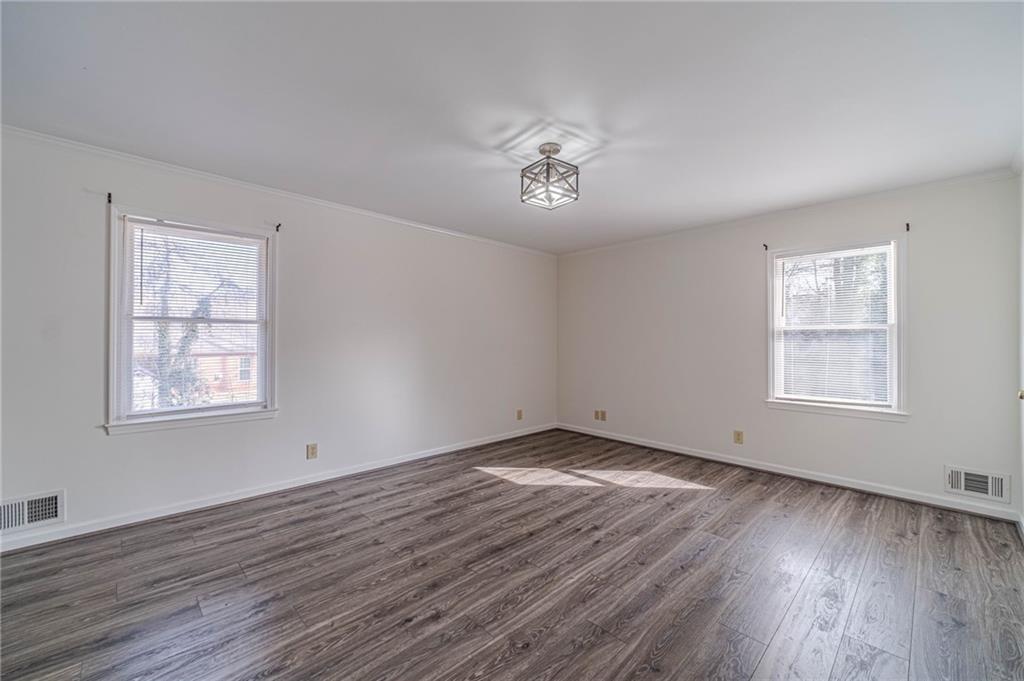 492 New Hope Road Lawrenceville, GA 30046 - Photo 25 of 48 a view of an empty room with wooden floor and a window