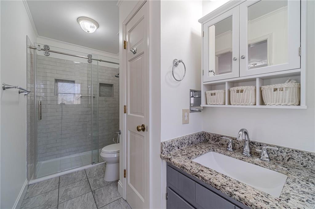 492 New Hope Road Lawrenceville, GA 30046 - Photo 28 of 48 a bathroom with a granite countertop sink toilet and shower
