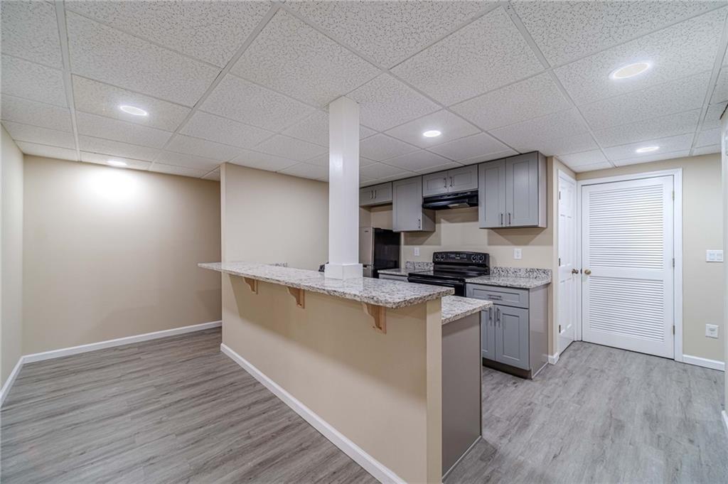 492 New Hope Road Lawrenceville, GA 30046 - Photo 31 of 48 a kitchen with a stove a sink and a refrigerator