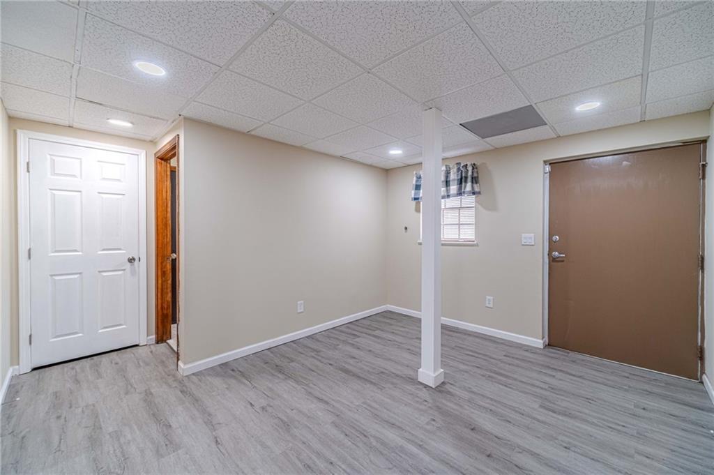 492 New Hope Road Lawrenceville, GA 30046 - Photo 33 of 48 an empty room with wooden floor and windows