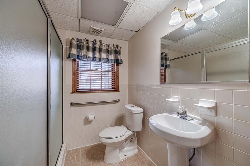 492 New Hope Road Lawrenceville, GA 30046 - Photo 34 of 48 a bathroom with a sink a toilet and mirror