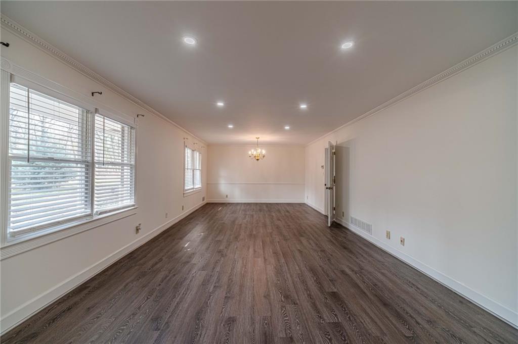 492 New Hope Road Lawrenceville, GA 30046 - Photo 6 of 48 an empty room with wooden floor and windows