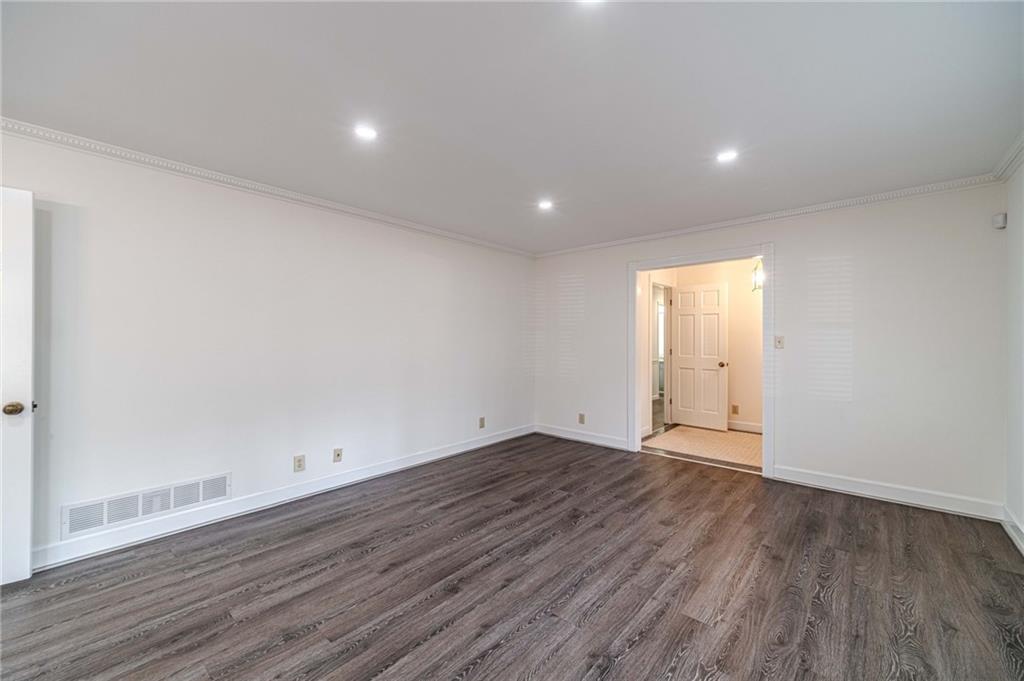 492 New Hope Road Lawrenceville, GA 30046 - Photo 8 of 48 a view of an empty room with wooden floor and closet