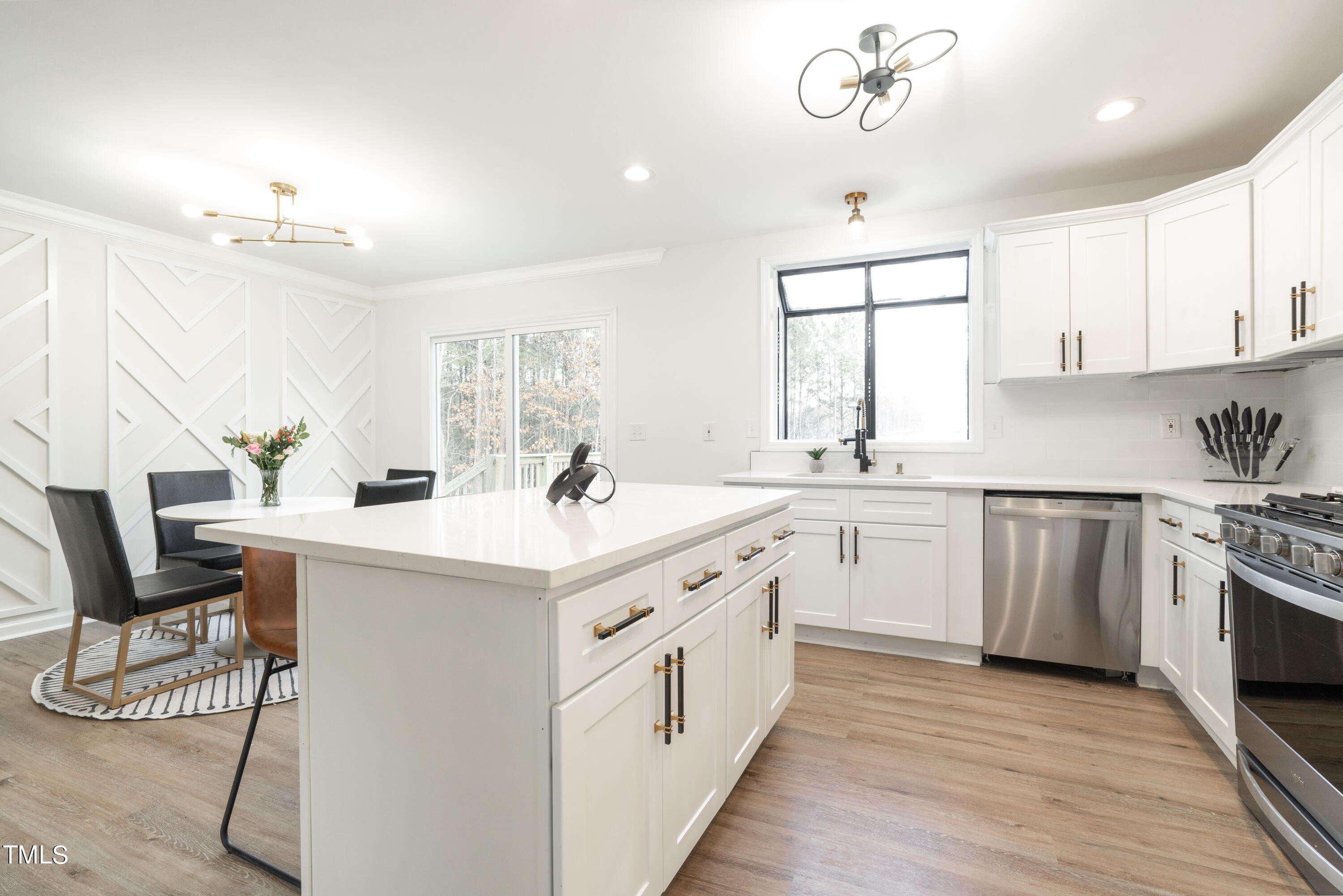 5017 Robinwood Road Durham, NC 27713 - Photo 11 of 45 a kitchen with a sink stove and cabinets