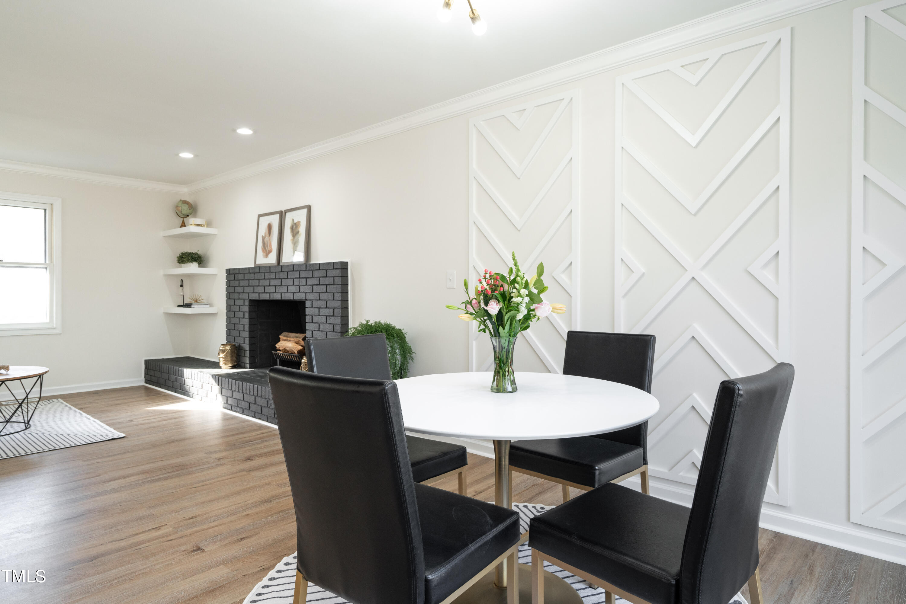 5017 Robinwood Road Durham, NC 27713 - Photo 15 of 45 a dining room with furniture potted plants and wooden floor