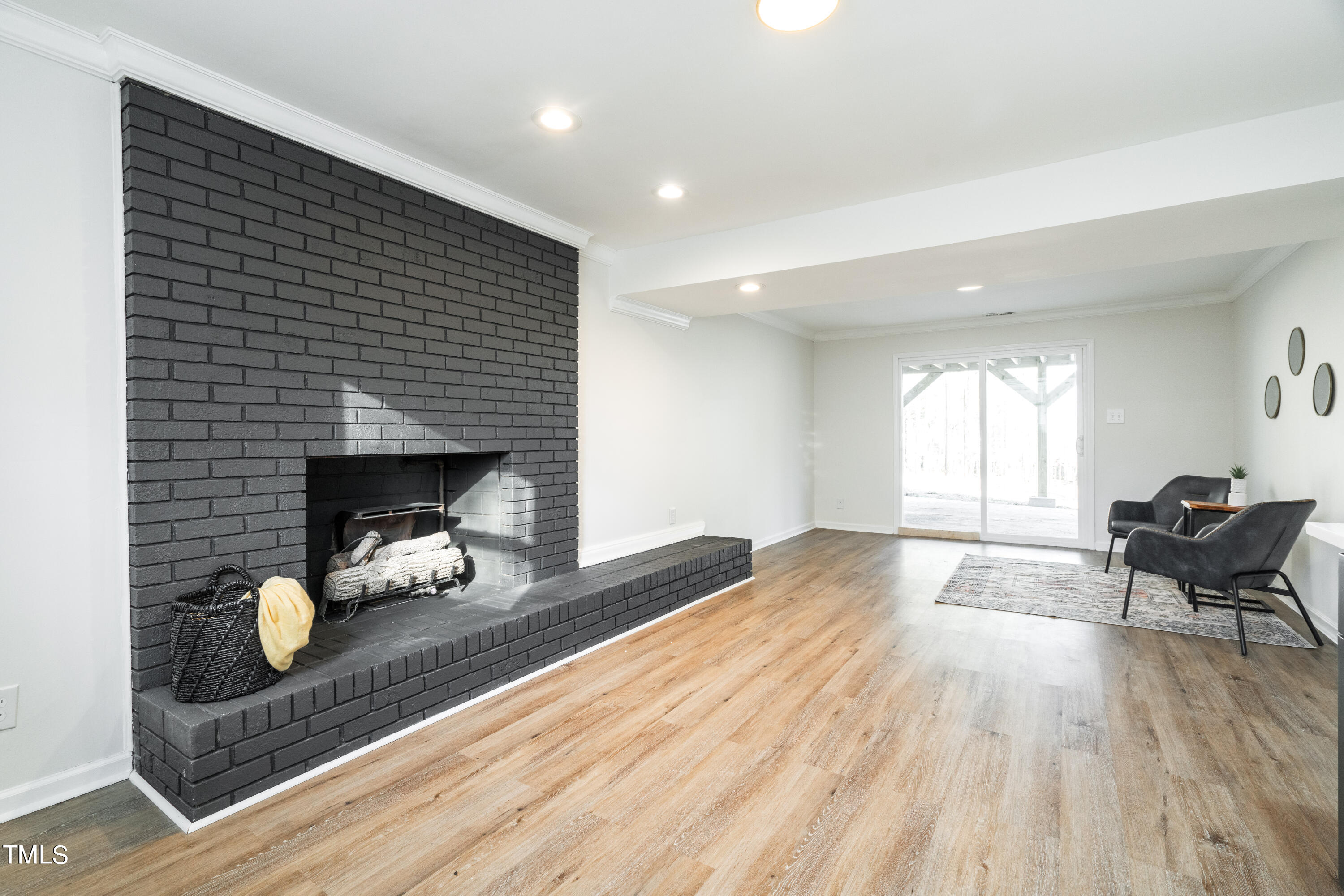 5017 Robinwood Road Durham, NC 27713 - Photo 27 of 45 a living room with furniture and a fireplace