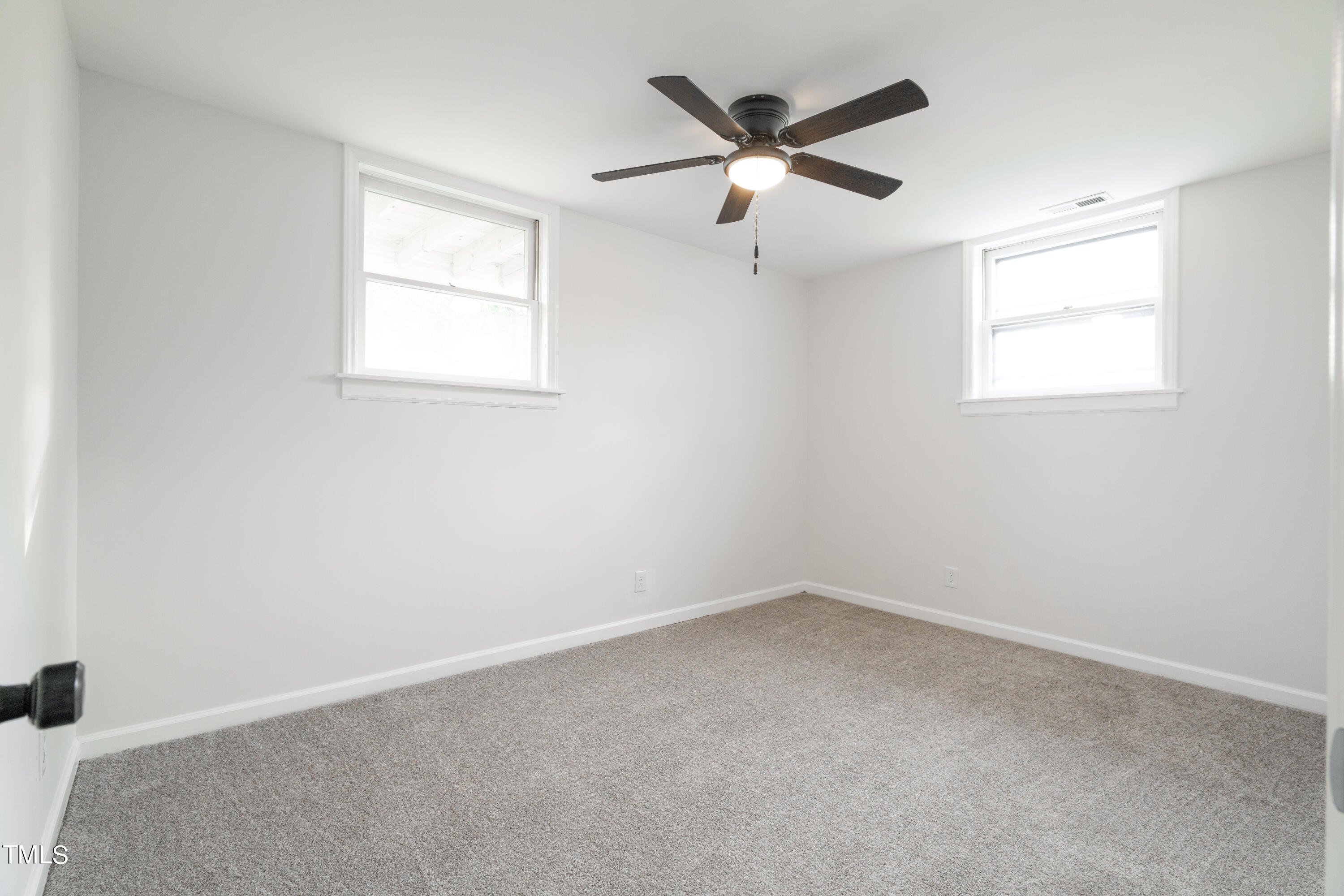 5017 Robinwood Road Durham, NC 27713 - Photo 31 of 45 an empty room with a window and a fan