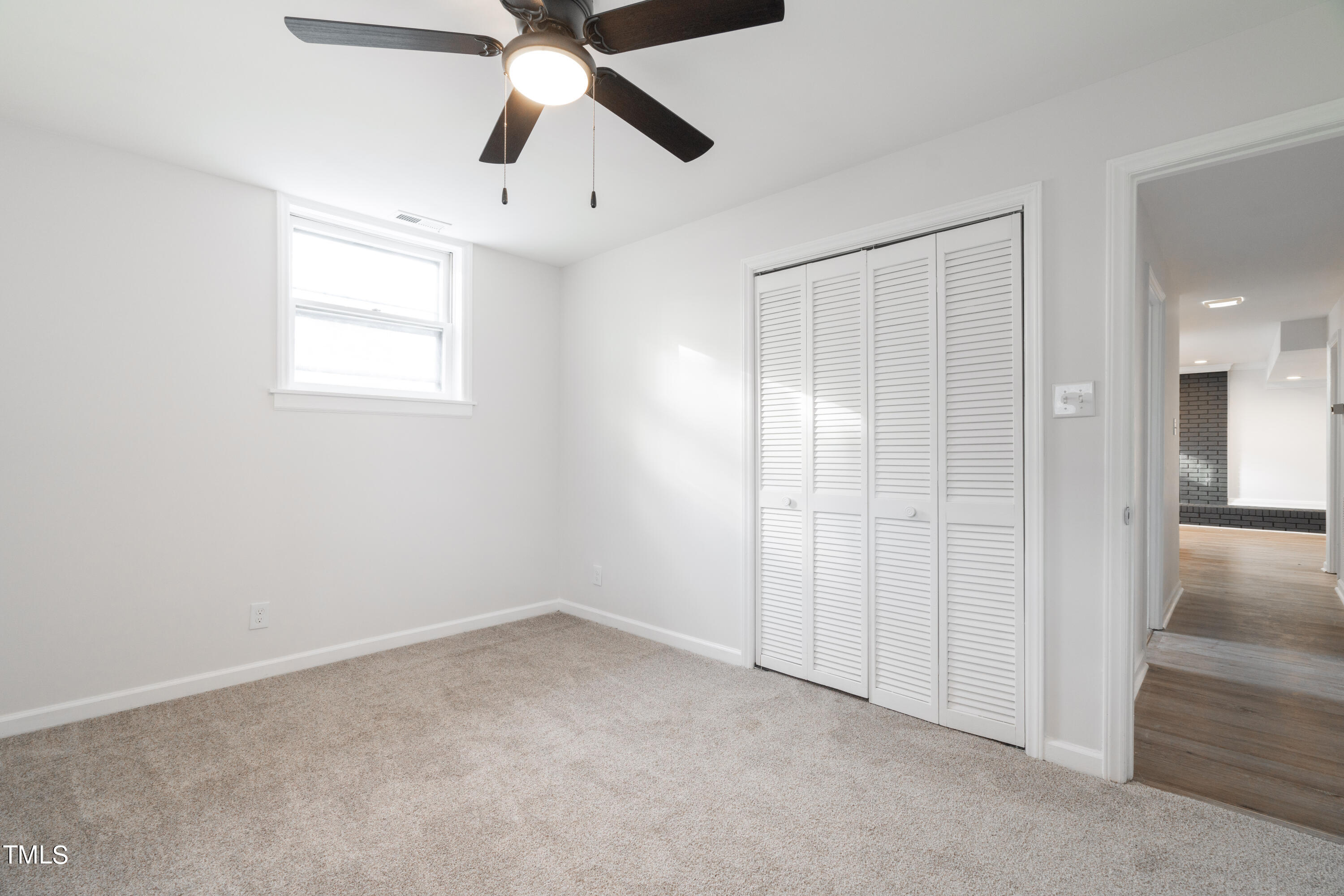 5017 Robinwood Road Durham, NC 27713 - Photo 32 of 45 an empty room with chandelier fan