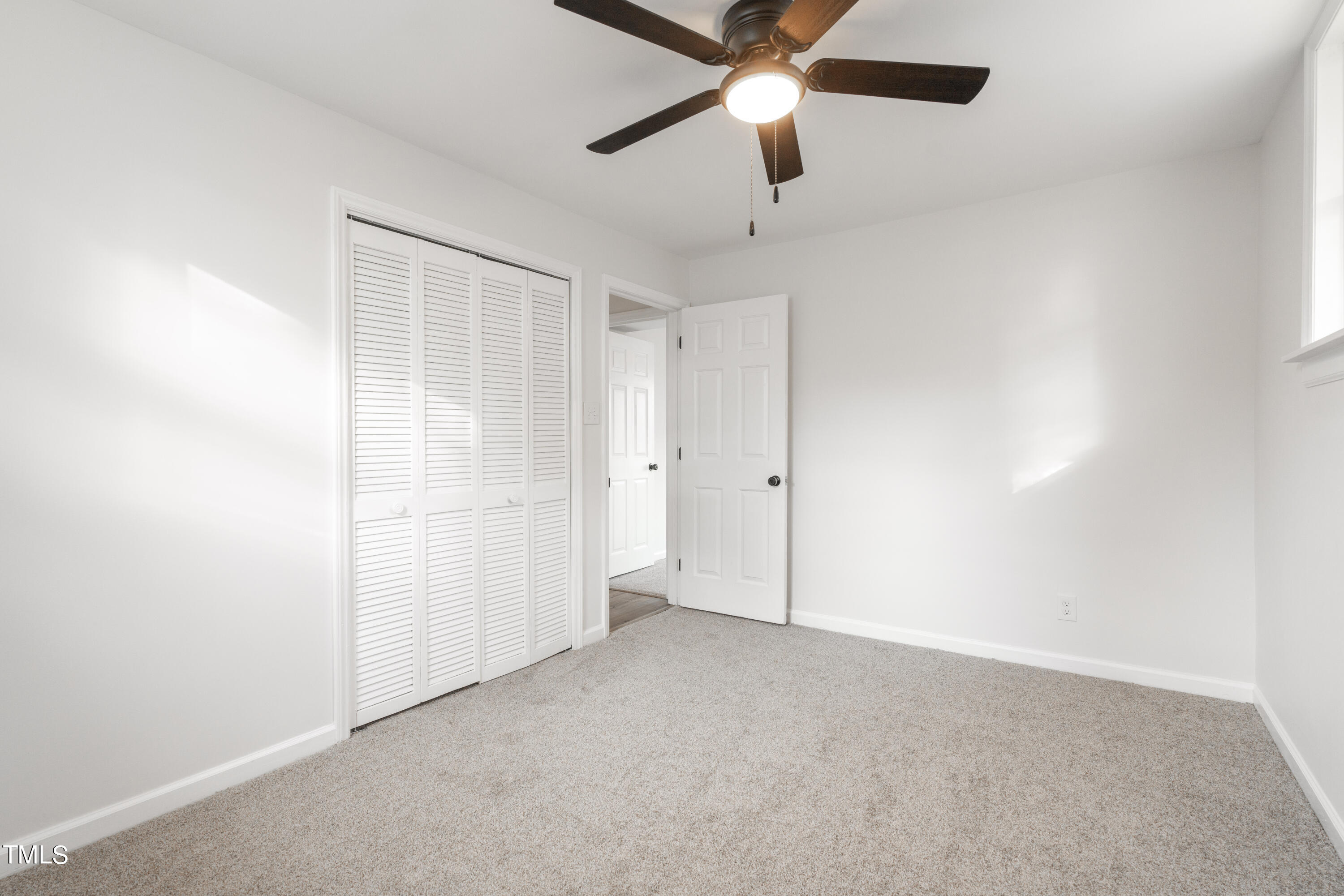 5017 Robinwood Road Durham, NC 27713 - Photo 33 of 45 an empty room with closet and fan