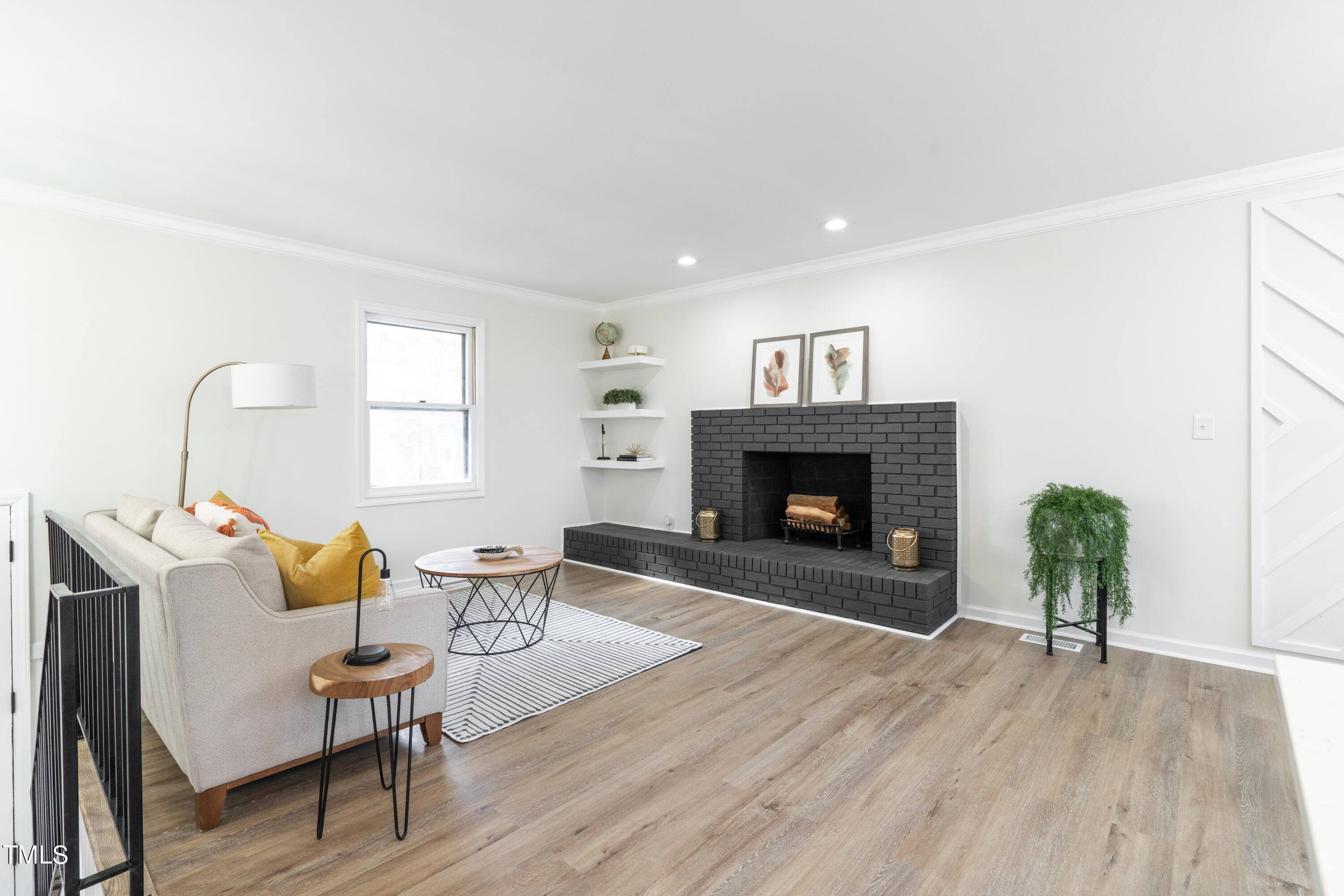 5017 Robinwood Road Durham, NC 27713 - Photo 6 of 45 a living room with furniture and a fireplace