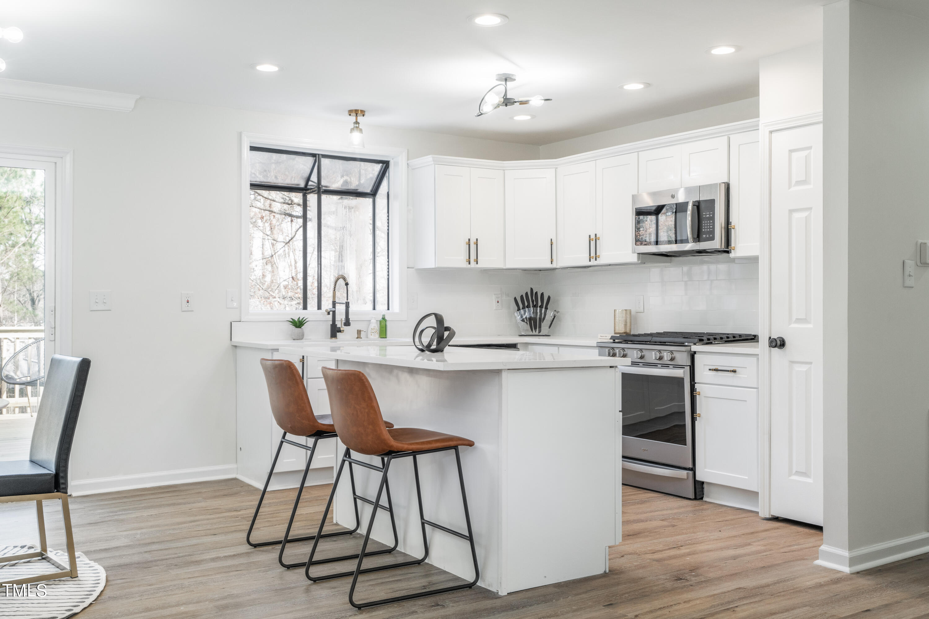 5017 Robinwood Road Durham, NC 27713 - Photo 9 of 45 a kitchen with stainless steel appliances a sink a stove a table and chairs