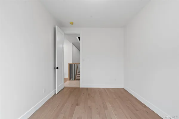 a view of a room with wooden floor