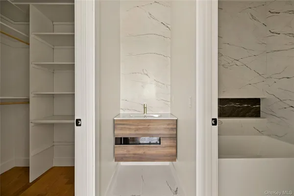 a view of walk in closet with empty racks