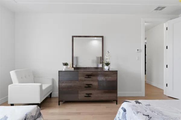 a room with a couch and a dresser