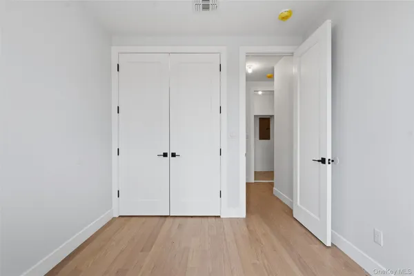 a view of hallway with wooden floor