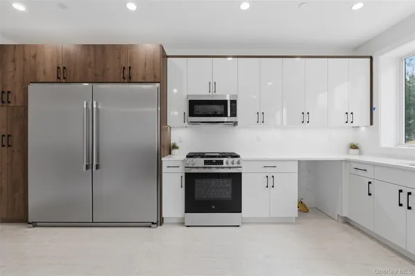 a kitchen with a refrigerator stove and cabinets