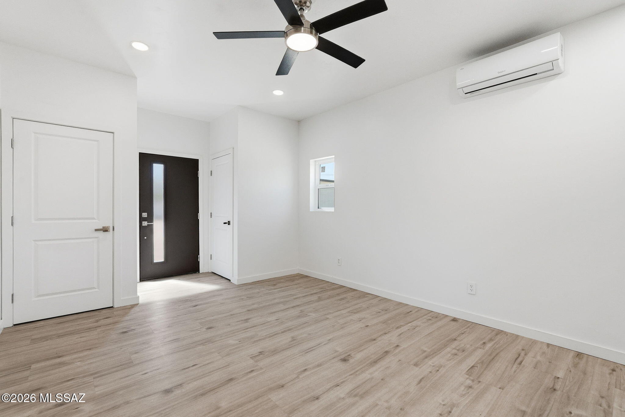 950 West Ina Road Tucson, AZ 85704 - Photo 35 of 54 an empty room with wooden floor and windows