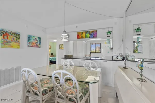 a living room with furniture and painting on the wall