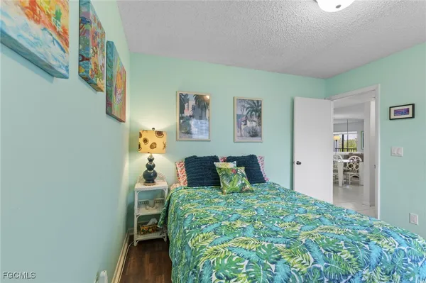 a bedroom with a bed and painting on the wall