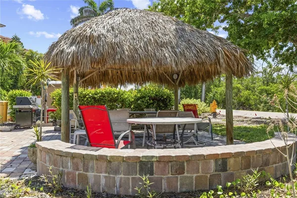 an aerial view of a city with lots of residential buildings ocean and mountain view in back