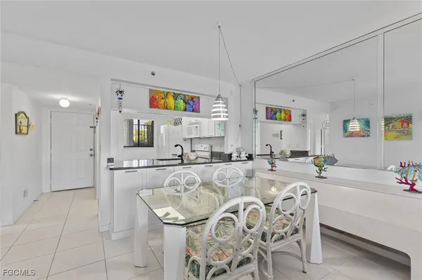 a large kitchen with a table and chairs