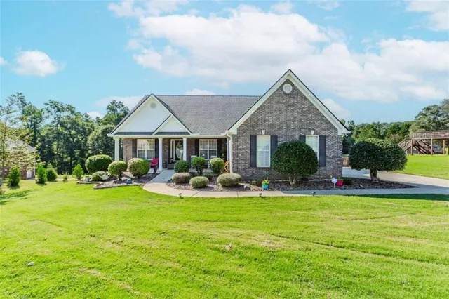 a front view of a house with swimming pool having outdoor seating