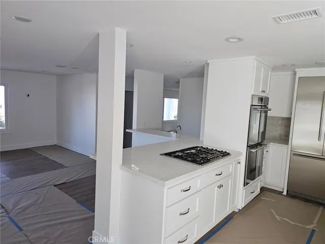 a kitchen that has a refrigerator and a stove