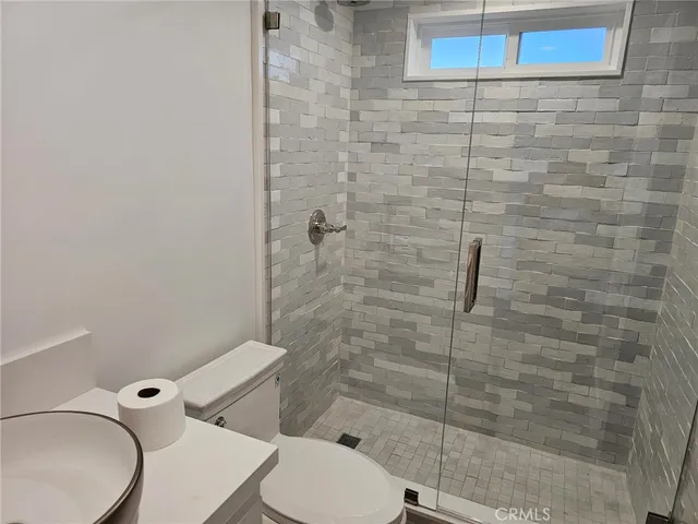 a bathroom with a toilet and a shower
