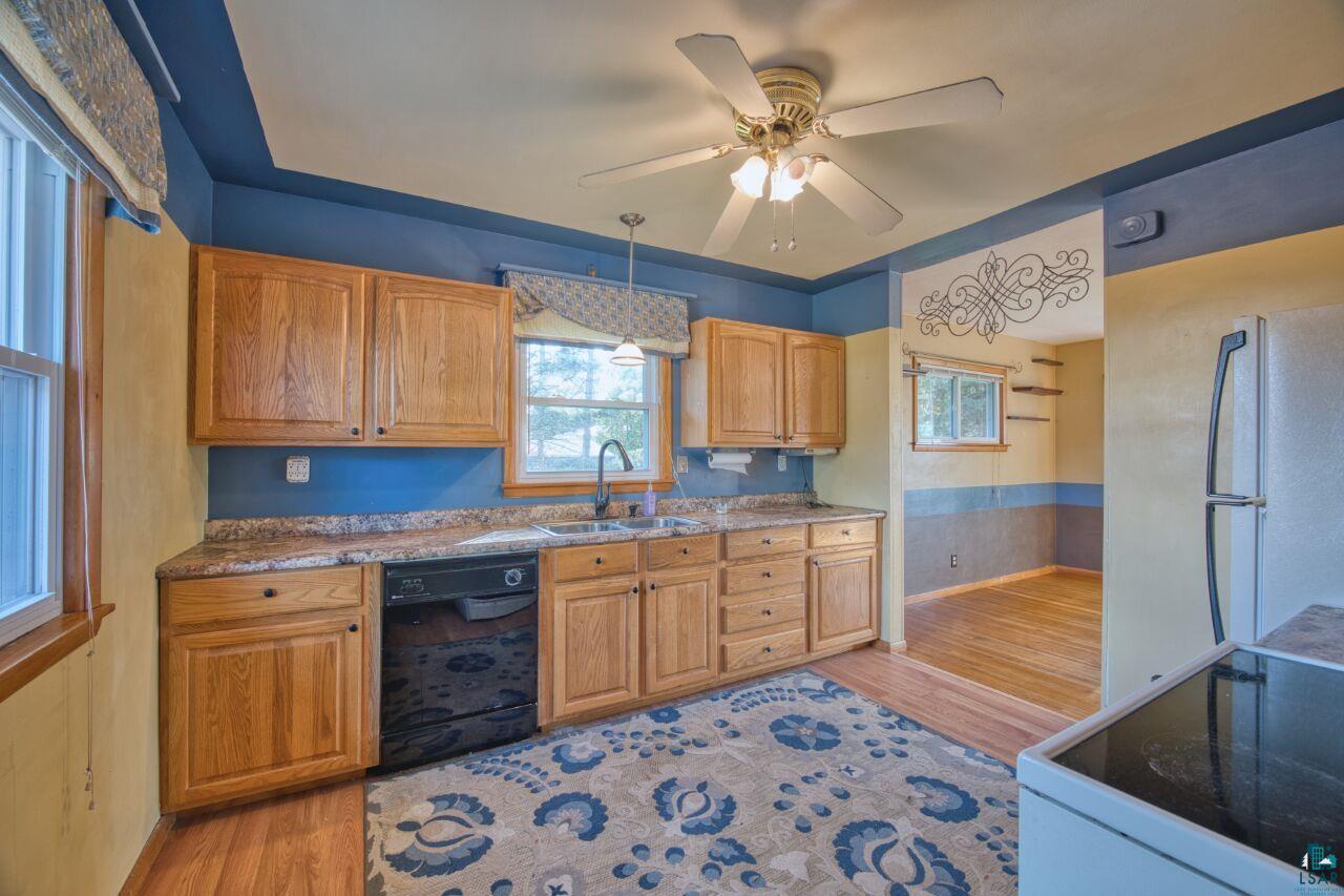 5316 Highway 110 Aurora, MN 55705 - Photo 7 of 35 Kitchen with white appliances, light wood-type flooring, ceiling fan, pendant lighting, and brown cabinetry