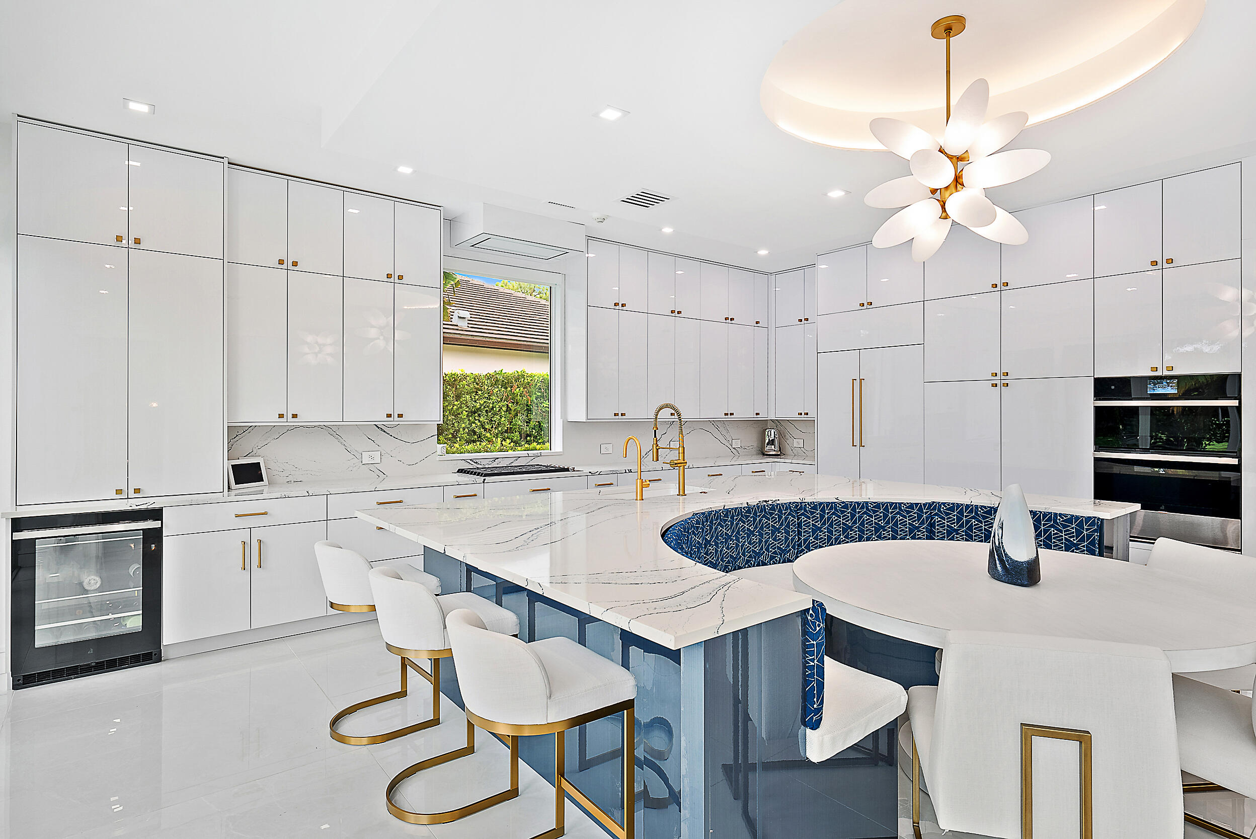 134 Golf Village Boulevard Jupiter, FL 33458 - Photo 12 of 48 a kitchen with a dining table chairs sink and stove