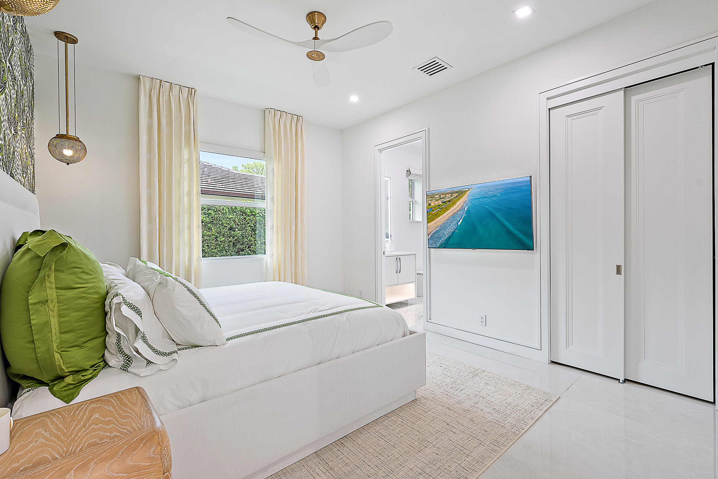 134 Golf Village Boulevard Jupiter, FL 33458 - Photo 24 of 48 a bedroom with a bed and a window