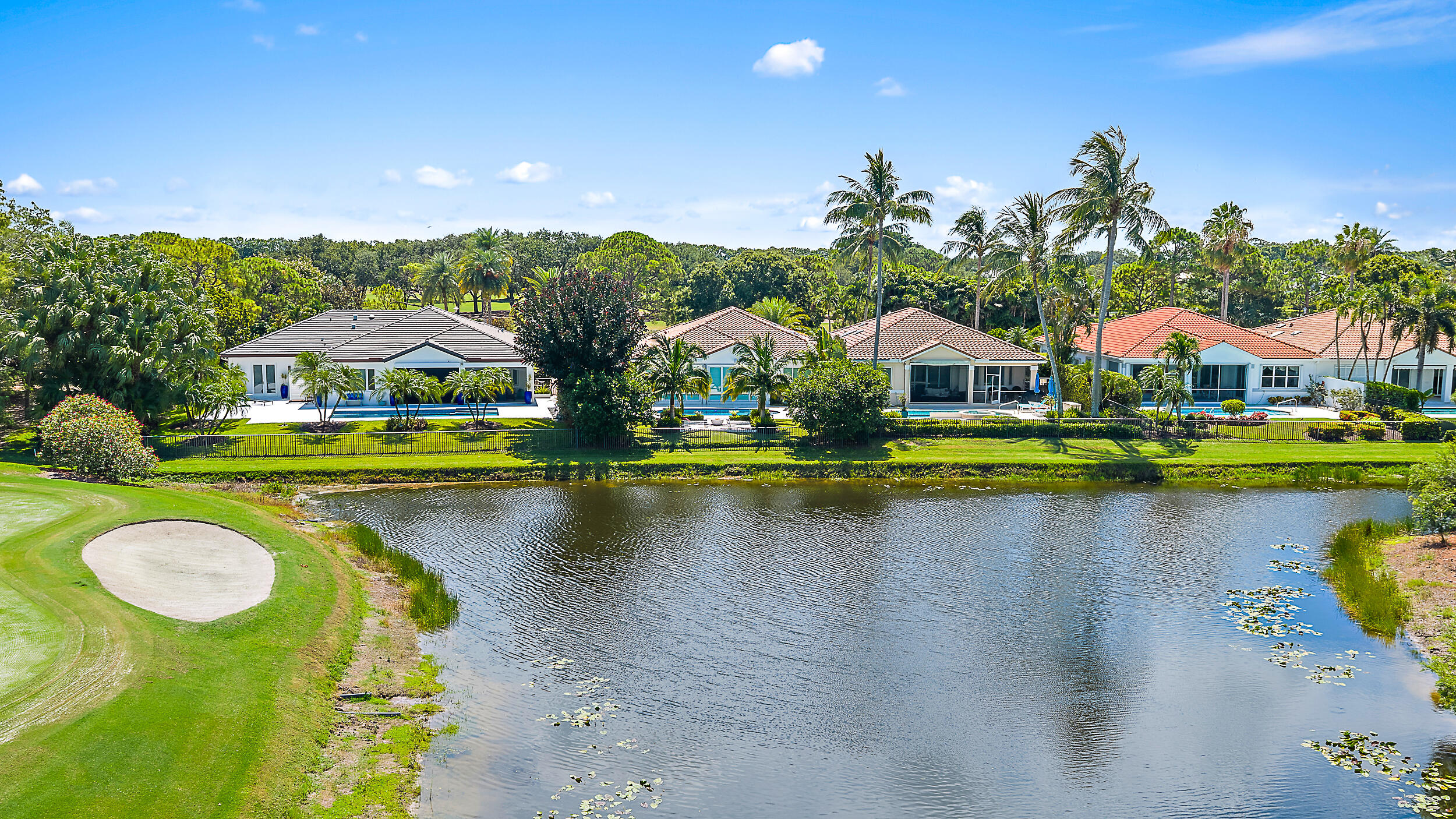134 Golf Village Boulevard Jupiter, FL 33458 - Photo 30 of 48 a view of a lake with houses swimming pool and outdoor space